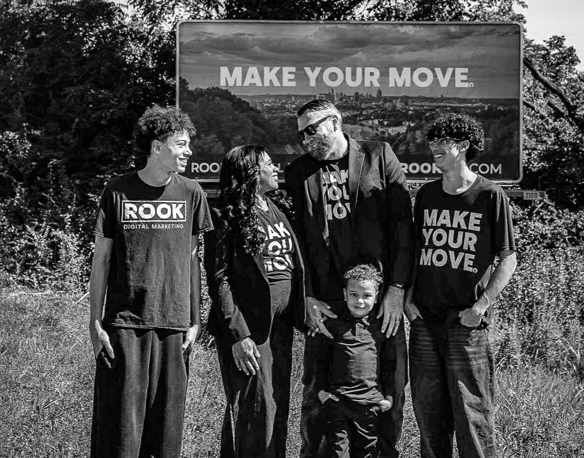 The ROOK crew in front of the MAKE YOUR MOVE billboard
